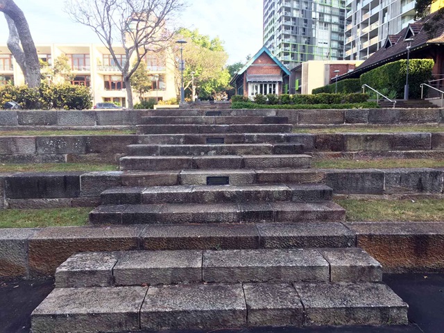 Terraced concrete steps leading towards the road.