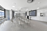 Chairs in rows in front of large display