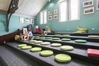 Step seating and people sitting on big cushions.