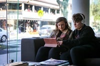 Two people using a laptop together