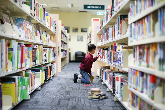 Woman stacking shelves in a library